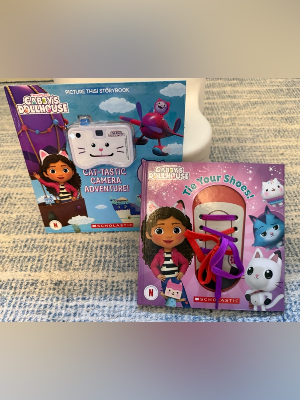 Scholastic Gabby’s Dollhouse Tie Your Shoes and camera activity book
